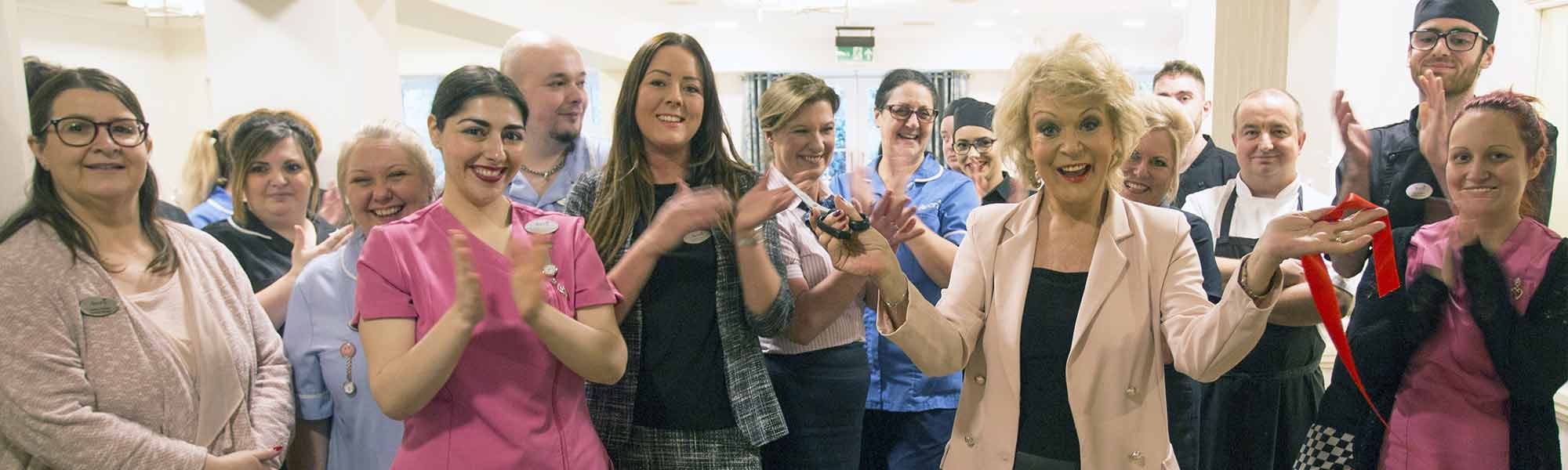 Sherrie Hewson Birchmere Mews celebrity visit staff ribbon clapping celebrating banner hero