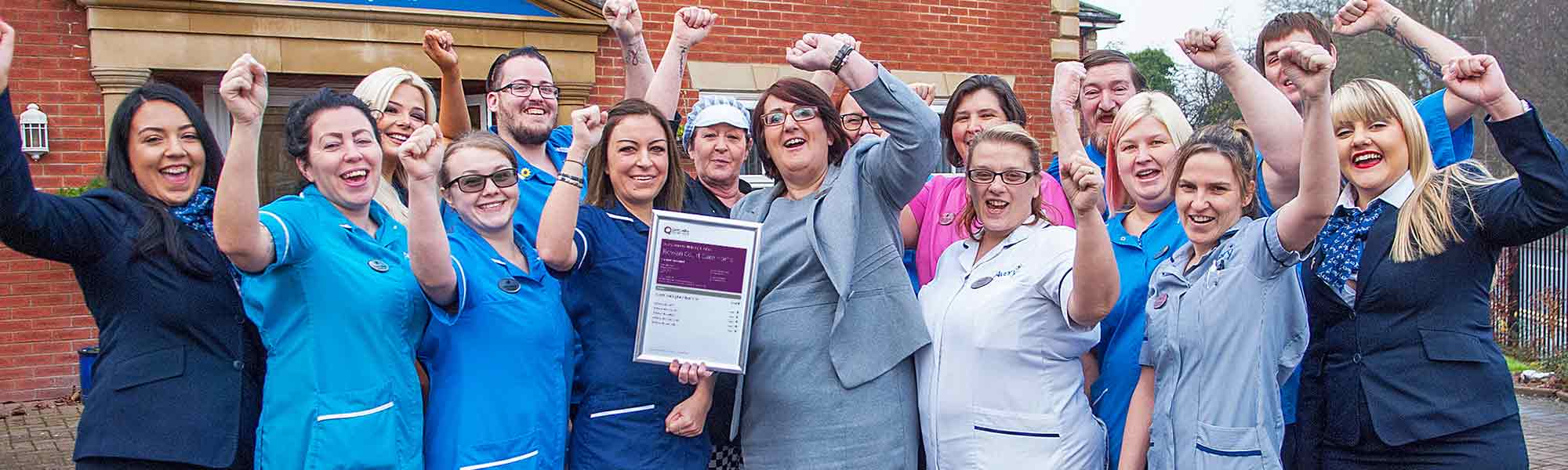 Staff at Rowan Court celebrate CQC GIAC banner hero